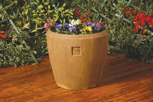 A large outdoor planter filled with colorful pansies